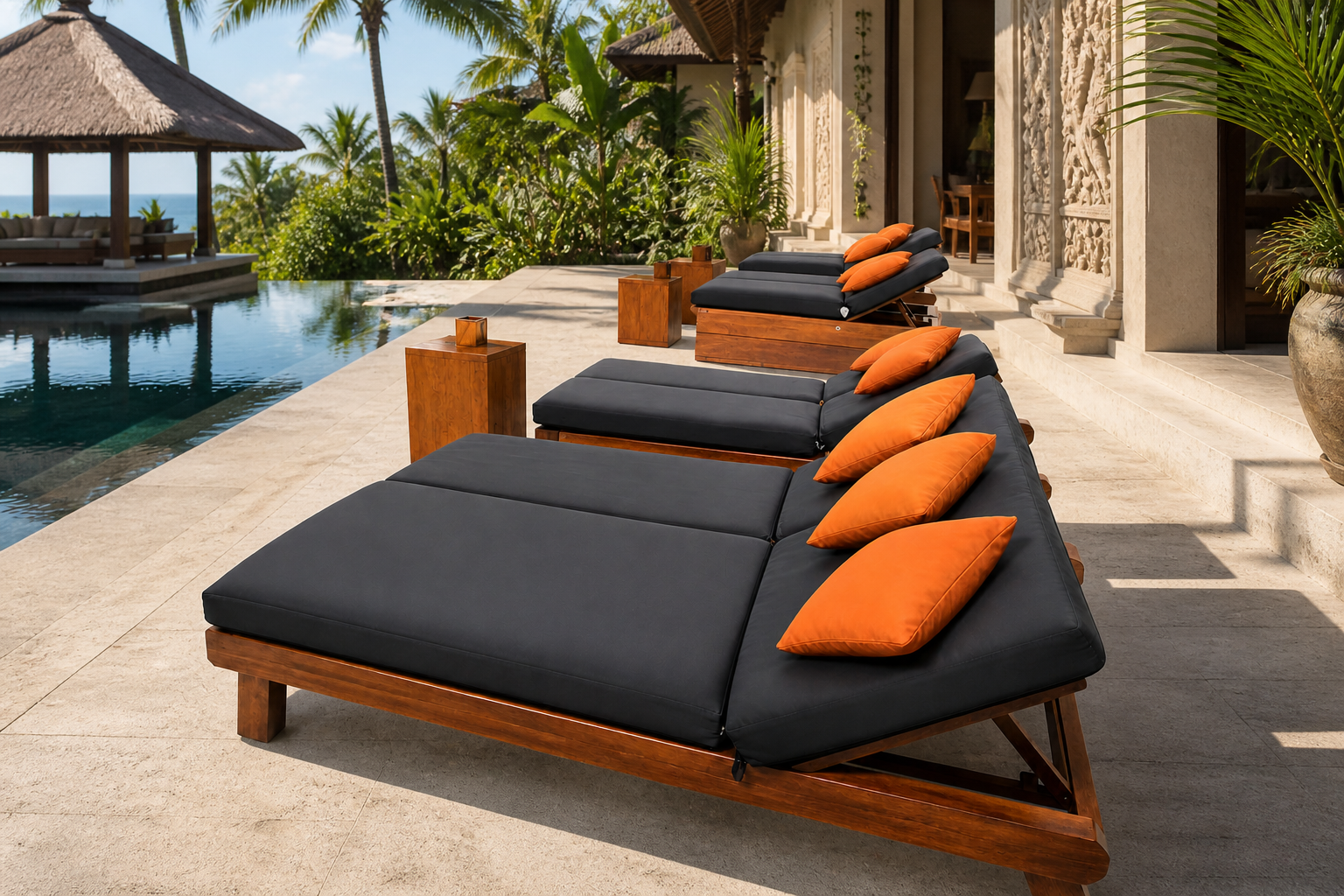 Black villa sun loungers with terracotta pillows beside a pool